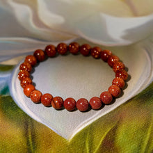 Load image into Gallery viewer, A collection of Red Sunstone bracelet showcasing different styles and sizes along with their Red Sunstone bracelet benefits.
