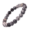 Model wearing a stylish Black Picasso Jasper bracelet to highlight its elegance and aesthetic appeal. Get to know more about the Black Picasso Jasper benefits