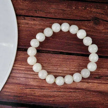 Load image into Gallery viewer, The White Agate bracelet with a focus on its vibrant color and unique texture.
