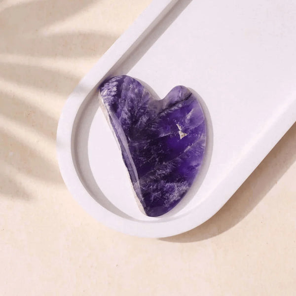 Amethyst beauty Gua Sha crystal showcased for calming, detoxifying and soothing facial massage.