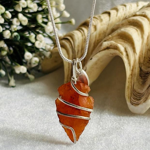 Carnelian crystal arrowhead necklace worn for passion, strength, and confidence