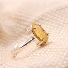 Load image into Gallery viewer, Close-up of Citrine diamond cut oval ring on a textured fabric surface, symbolizing success, prosperity and positive energy.
