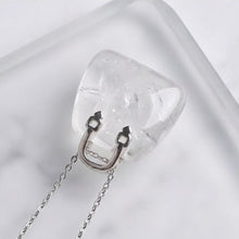 Load image into Gallery viewer, Clear Quartz Mini Handbag Pendant – Symbol of Energy, Amplification, and Clarity – Perfect for Daily Wear - Lifestyle View | Natural Sphatik, Seven Chakra Crystal Ring for Chakra Balance &amp; Energy Alignment
