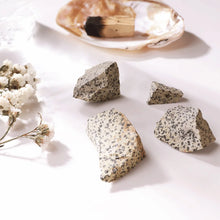 Load image into Gallery viewer, Dalmatian Jasper raw stones placed on a table, symbolizing joy, stability, and grounding energy.

