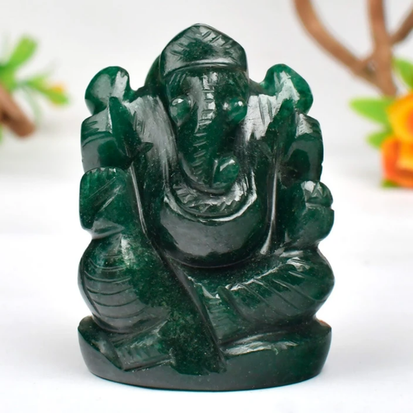 Dark green Ganesh stone figurine, front view on white background, showing polished carved details