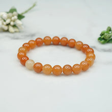 Load image into Gallery viewer, Model wearing a stylish Red Aventurine bracelet to highlight its elegance and aesthetic appeal. Get to know more about the Red Aventurine benefits
