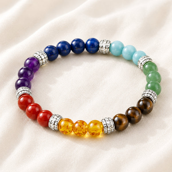 7 Chakra Bracelet displayed fully on white silk cloth to show its natural colour, shape and finish