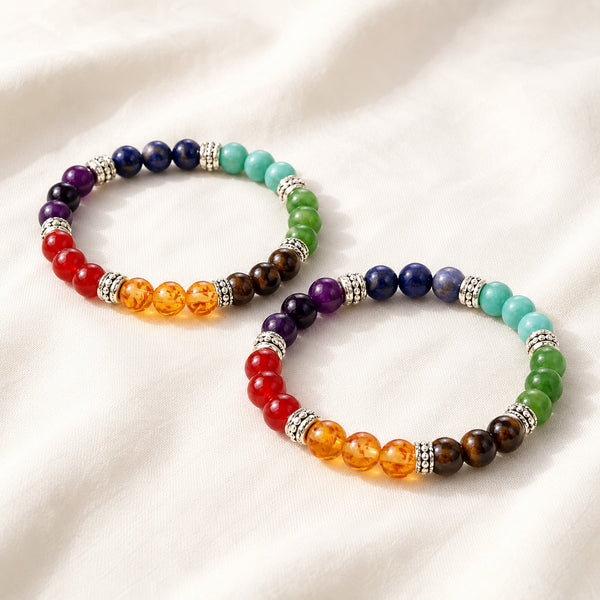 Pack of 2- 7 Chakra Bracelet Pack displayed fully on white silk cloth to show its natural colour, shape and finish