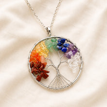 Load image into Gallery viewer, 7 Chakra Tree of Life Pendant displayed fully on white silk cloth to show its natural colour, shape and finish
