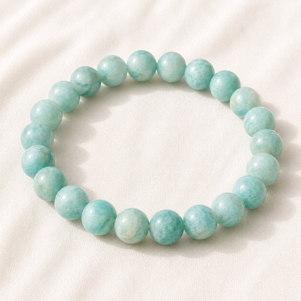 Amazonite Bracelet displayed fully on white silk cloth to show its natural colour, shape and finish