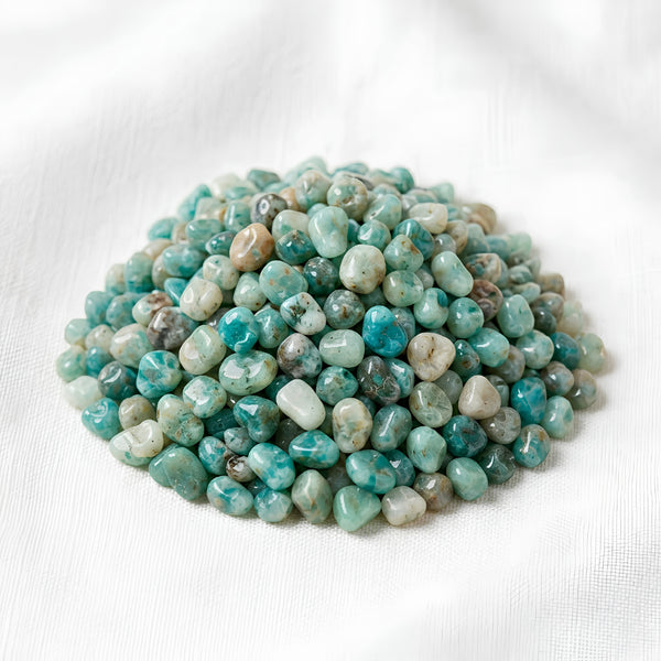 Amazonite Chips displayed fully on white silk cloth to show its natural colour, shape and finish