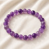 Amethyst Bracelet displayed fully on white silk cloth to show its natural colour, shape and finish