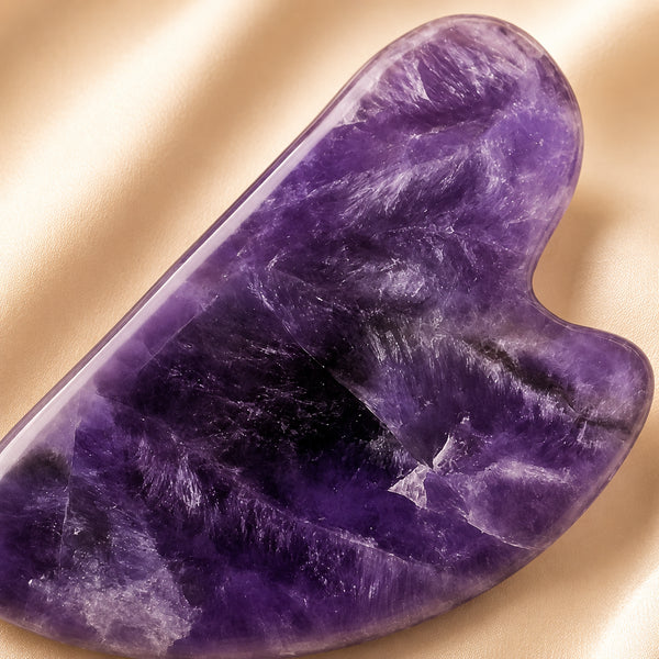 Close-up of authentic natural Amethyst showing crystal texture, colour and craftsmanship – amethyst gua sha symbol of serenity wisdom and spiritual release