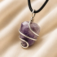 Load image into Gallery viewer, Amethyst Tumble Pendant displayed fully on white silk cloth to show its natural colour, shape and finish
