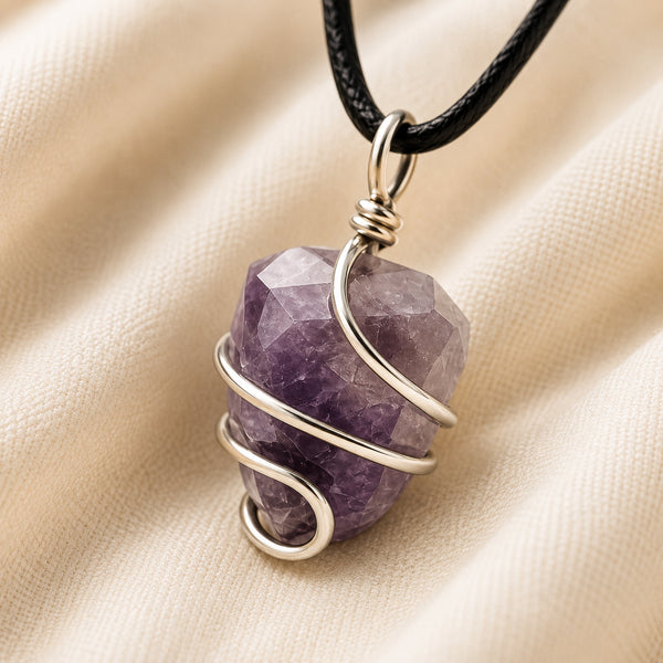 Amethyst Tumble Pendant displayed fully on white silk cloth to show its natural colour, shape and finish