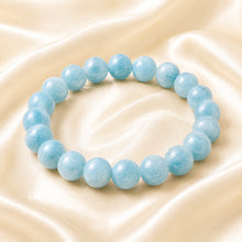 Load image into Gallery viewer, Aquamarine Bracelet displayed fully on white silk cloth to show its natural colour, shape and finish
