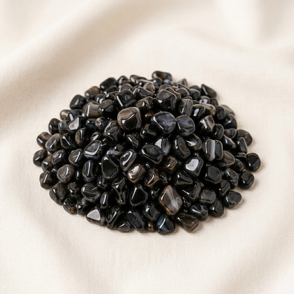 Black Agate Chips displayed fully on white silk cloth to show its natural colour, shape and finish