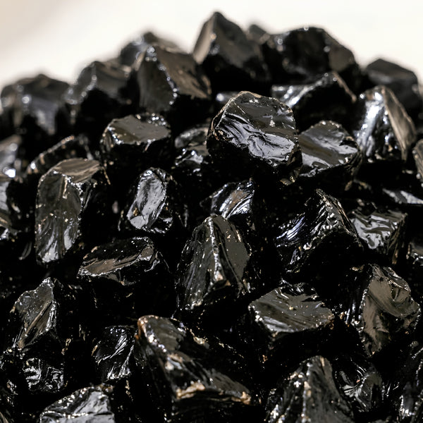 Close-up of authentic natural Black Obsidian showing crystal texture, colour and craftsmanship – black obsidian chips stone symbol of protection grounding and