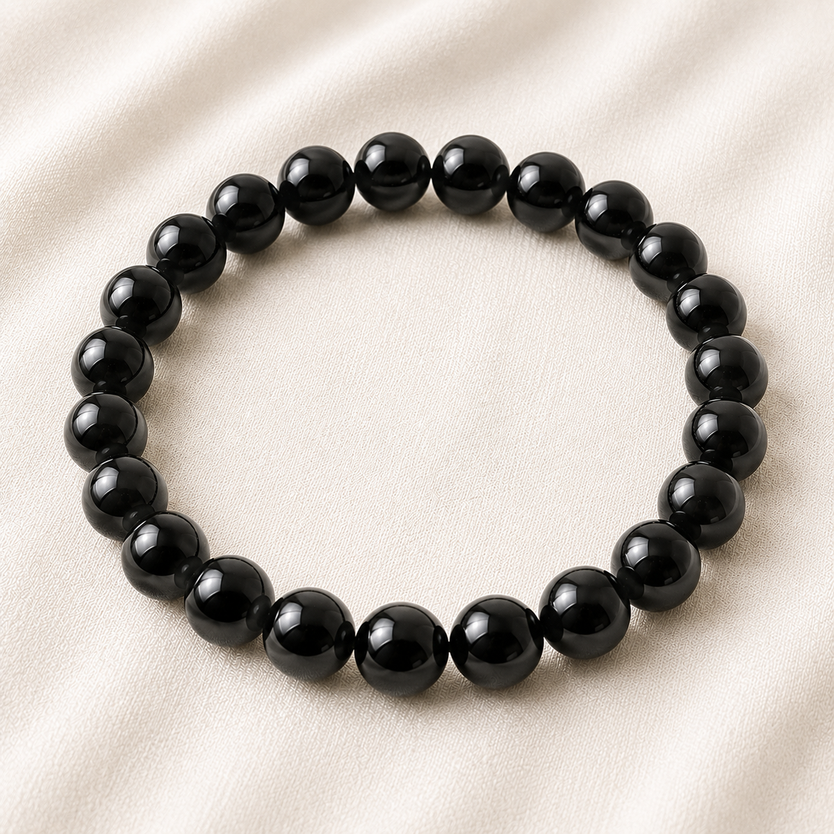 Black Onyx Bracelet displayed fully on white silk cloth to show its natural colour, shape and finish