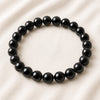 Black Onyx Bracelet displayed fully on white silk cloth to show its natural colour, shape and finish
