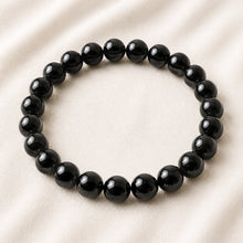 Load image into Gallery viewer, Black Onyx Bracelet displayed fully on white silk cloth to show its natural colour, shape and finish
