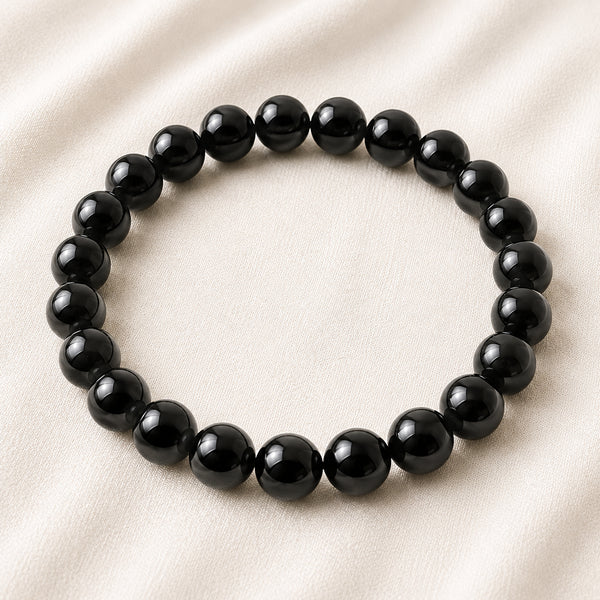 Black Onyx Bracelet displayed fully on white silk cloth to show its natural colour, shape and finish