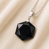 Close-up of authentic natural Black Tourmaline showing crystal texture, colour and craftsmanship – black tourmaline hexagon pendant symbol of guarding grounding