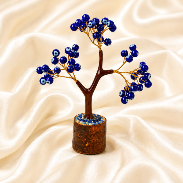 Blue Evil Eye Crystal Tree displayed fully on white silk cloth to show its natural colour, shape and finish