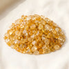 Citrine Chips displayed fully on white silk cloth to show its natural colour, shape and finish