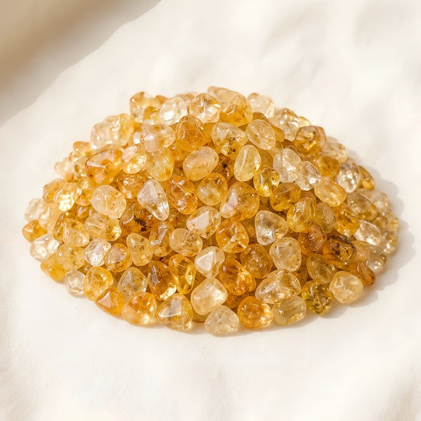 Citrine Chips displayed fully on white silk cloth to show its natural colour, shape and finish