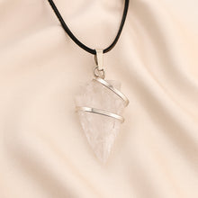 Load image into Gallery viewer, Clear Quartz Arrowhead Pendant displayed fully on white silk cloth to show its natural colour, shape and finish
