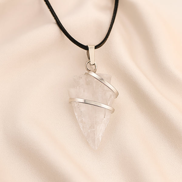 Clear Quartz Arrowhead Pendant displayed fully on white silk cloth to show its natural colour, shape and finish