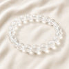 Clear Quartz Bracelet displayed fully on white silk cloth to show its natural colour, shape and finish