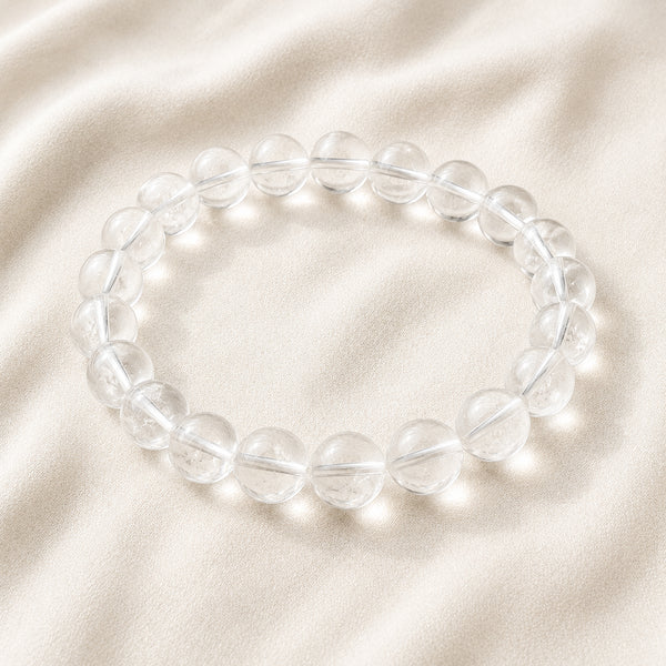 Clear Quartz Bracelet displayed fully on white silk cloth to show its natural colour, shape and finish