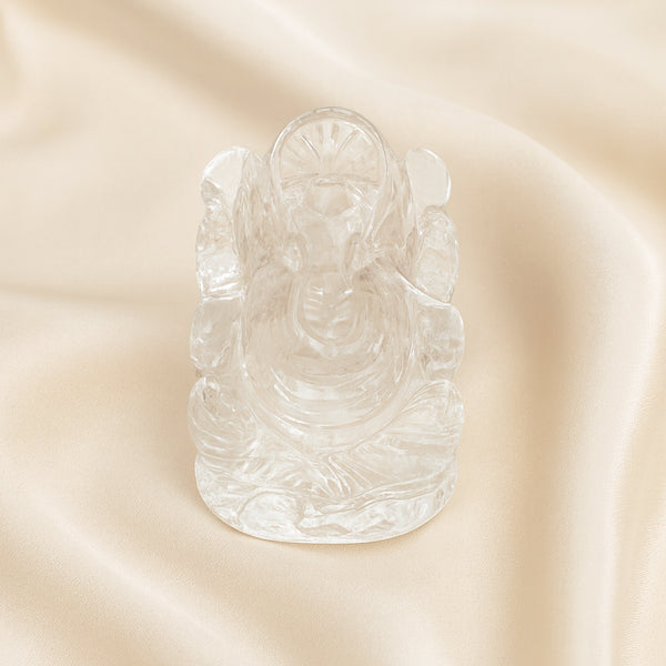 Sphatik Ganesh Idol displayed fully on white silk cloth to show its natural colour, shape and finish