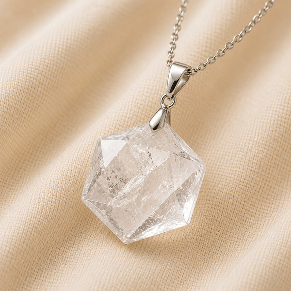 Clear Quartz Hexagon Pendant displayed fully on white silk cloth to show its natural colour, shape and finish