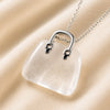 Close-up of authentic natural Clear Quartz showing crystal texture, colour and craftsmanship – clear quartz mini handbag pendant symbol of energy amplification