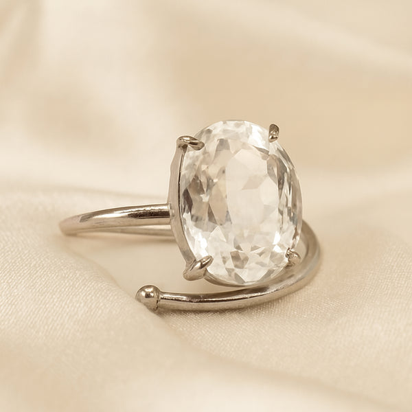 Clear Quartz Adjustable Ring displayed fully on white silk cloth to show its natural colour, shape and finish
