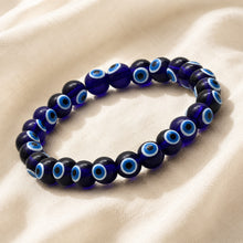 Load image into Gallery viewer, Evil Eye Bracelet displayed fully on white silk cloth to show its natural colour, shape and finish
