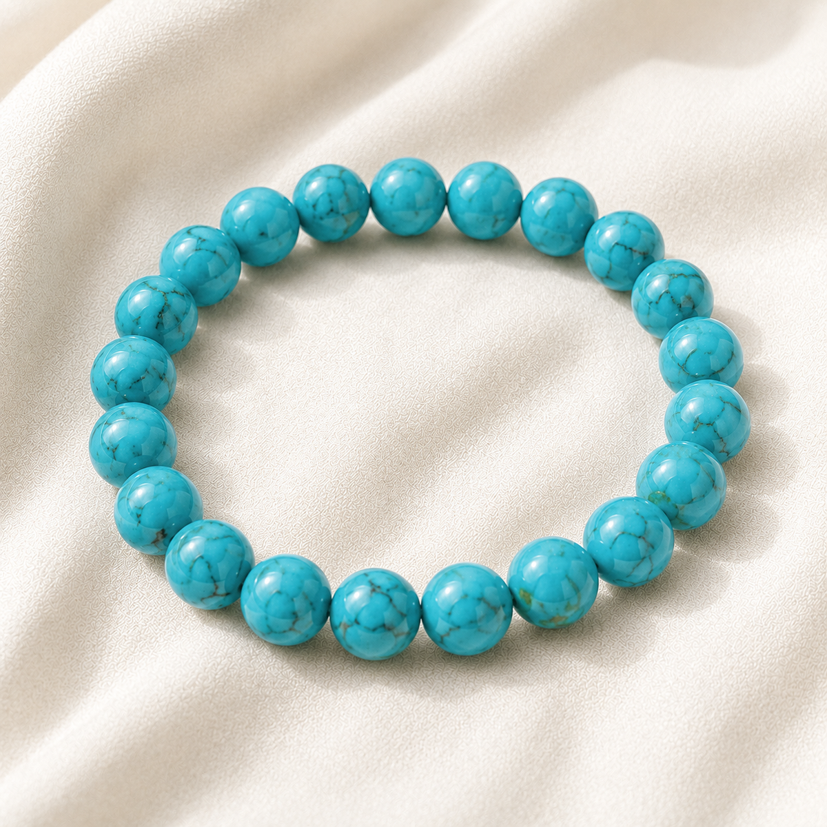 Firoza Bracelet displayed fully on white silk cloth to show its natural colour, shape and finish