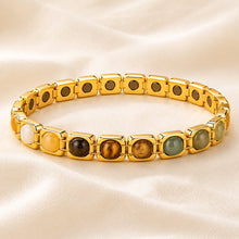 Load image into Gallery viewer, Golden Plated Money Magnet Bracelet displayed fully on white silk cloth to show its natural colour, shape and finish
