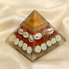 Gomti Chakra Orgone Pyramid displayed fully on white silk cloth to show its natural colour, shape and finish