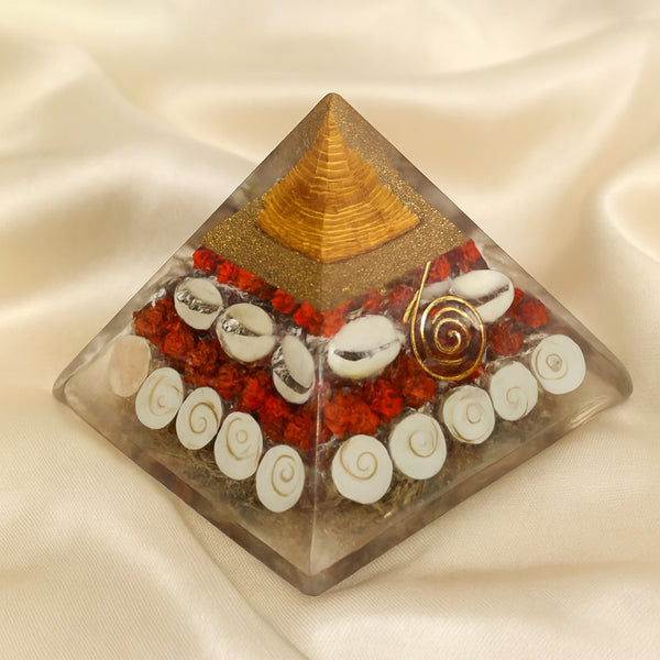 Gomti Chakra Orgone Pyramid displayed fully on white silk cloth to show its natural colour, shape and finish