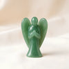 Green Aventurine Angel Figurine displayed fully on white silk cloth to show its natural colour, shape and finish