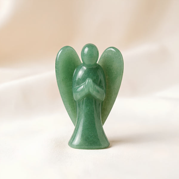 Green Aventurine Angel Figurine displayed fully on white silk cloth to show its natural colour, shape and finish