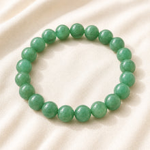 Load image into Gallery viewer, Green Aventurine Bracelet displayed fully on white silk cloth to show its natural colour, shape and finish
