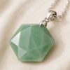 Close-up of authentic natural Green Aventurine showing crystal texture, colour and craftsmanship – green aventurine hexagon pendant symbol of luck longevity and