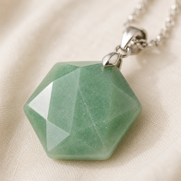 Close-up of authentic natural Green Aventurine showing crystal texture, colour and craftsmanship – green aventurine hexagon pendant symbol of luck longevity and