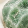 Close-up of authentic natural Green Aventurine showing crystal texture, colour and craftsmanship – green aventurine raw stone symbol of opportunity prosperity