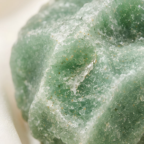Close-up of authentic natural Green Aventurine showing crystal texture, colour and craftsmanship – green aventurine raw stone symbol of opportunity prosperity
